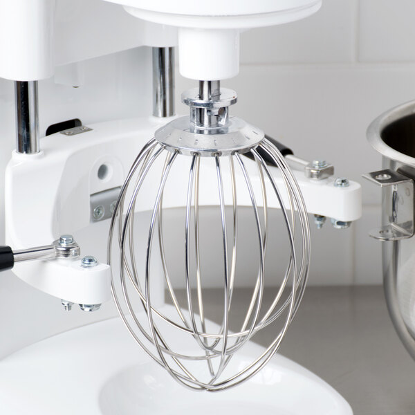 A close-up of a Globe stainless steel wire whisk.