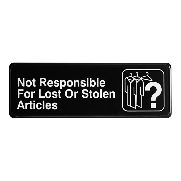 A black sign with white text that says "Not responsible for lost or stolen articles"
