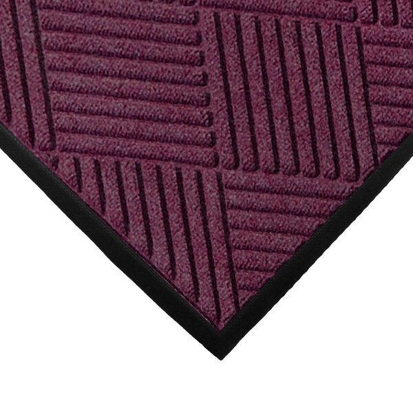 A purple WaterHog Classic mat with black stripes and a rubber border.