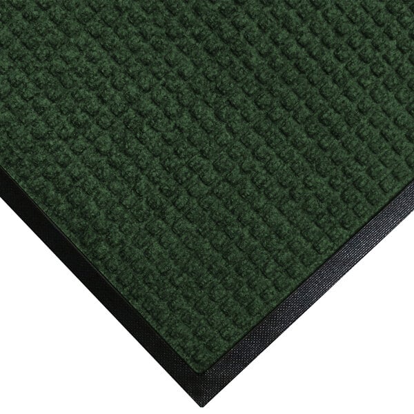 A green WaterHog carpet with black rubber trim.