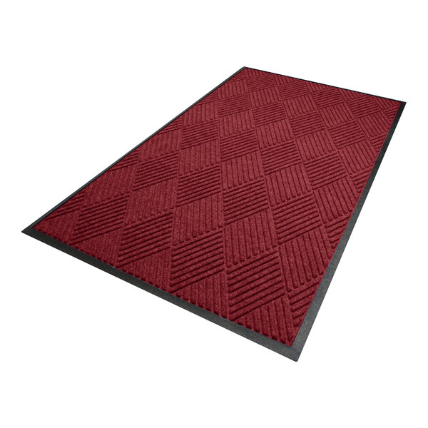 A rectangular red mat with a diamond pattern and a black border.
