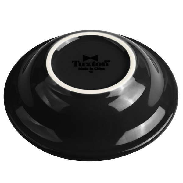 A black Tuxton China bowl with a white rim.