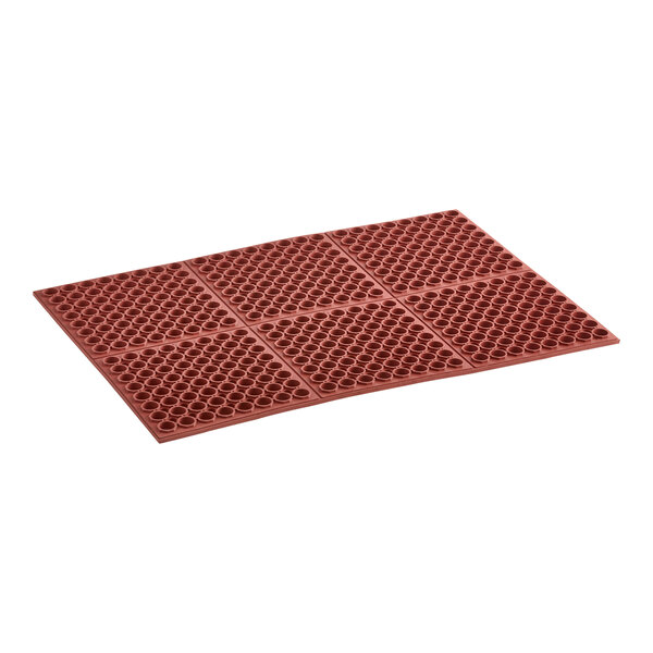 A close-up of a red Lavex rubber anti-fatigue floor mat with circles on it.