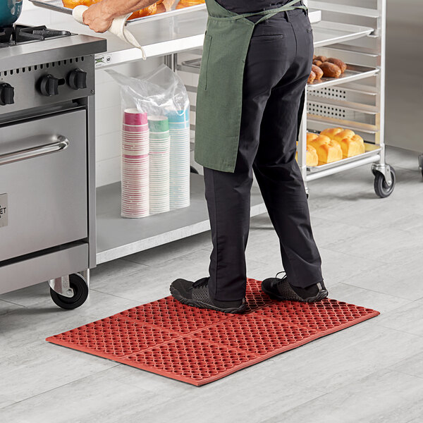 A man standing on a red Lavex anti-fatigue floor mat.
