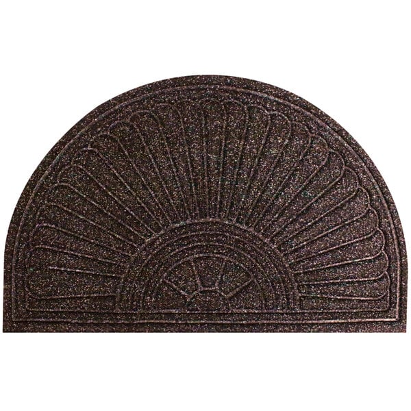 A close-up of a WaterHog half oval brown doormat with a circular sun design.
