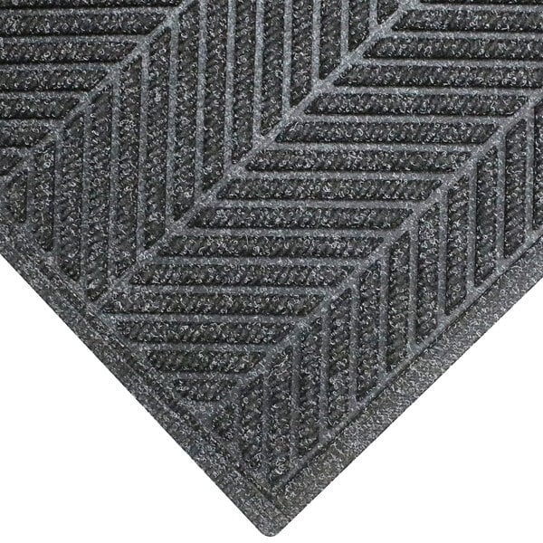 A close-up of a grey M+A Matting WaterHog Eco Elite mat with a chevron pattern and black border.