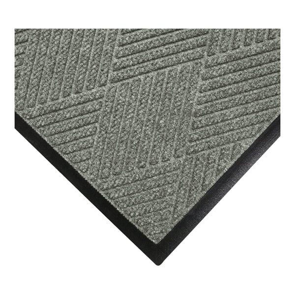 A close-up view of a gray textured mat with diagonal line patterns and a black rubber border.