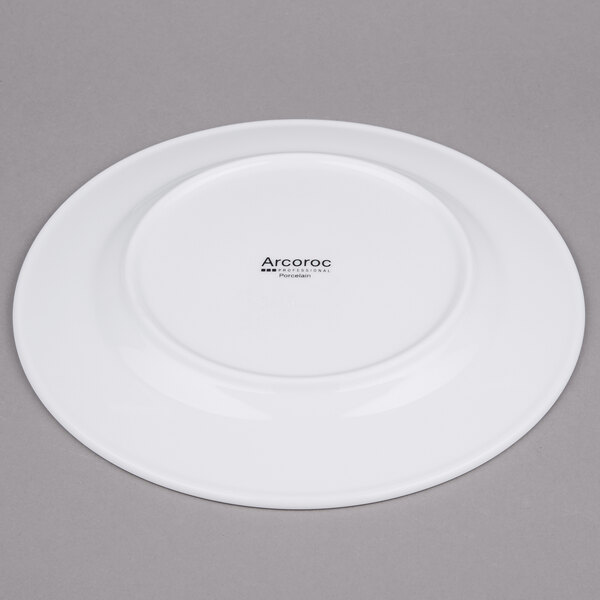A white Arcoroc brunch plate with a black rim.