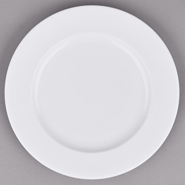A white porcelain brunch plate with a white rim on a gray surface.