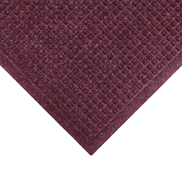 A WaterHog Bordeaux mat with a square pattern on the border.