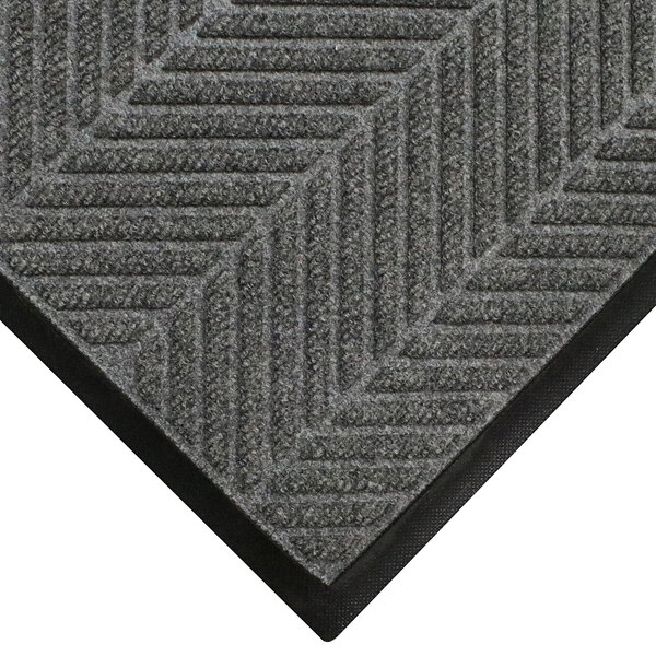 A grey WaterHog mat with a black border and chevron pattern.