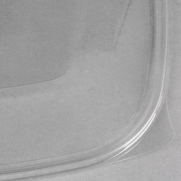 A clear Sabert plastic lid with a curved edge.