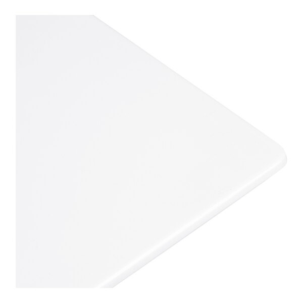 A close-up view of a smooth, white, rectangular surface with rounded edges.