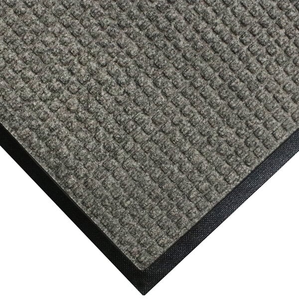 A close up of a grey carpet mat with black border.