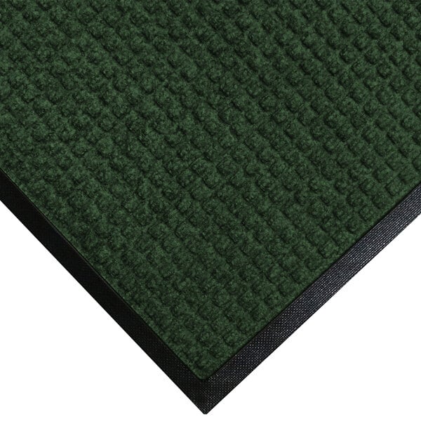 A green WaterHog entrance mat with black rubber trim.