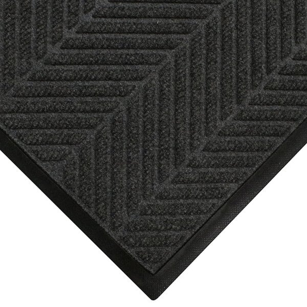 A close up of a black WaterHog mat with a chevron pattern and a classic border.