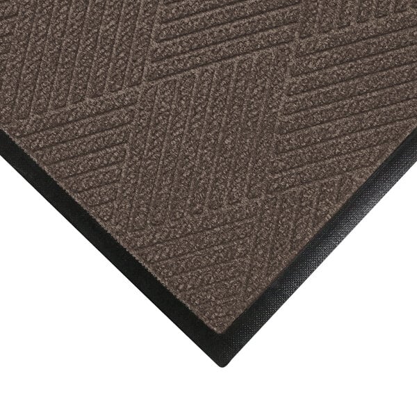 A close-up of a brown WaterHog mat with a black border.