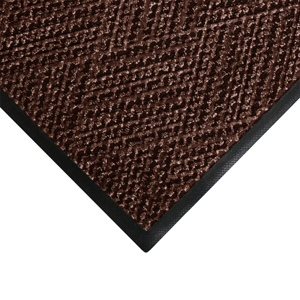 A brown WaterHog doormat with black trim.