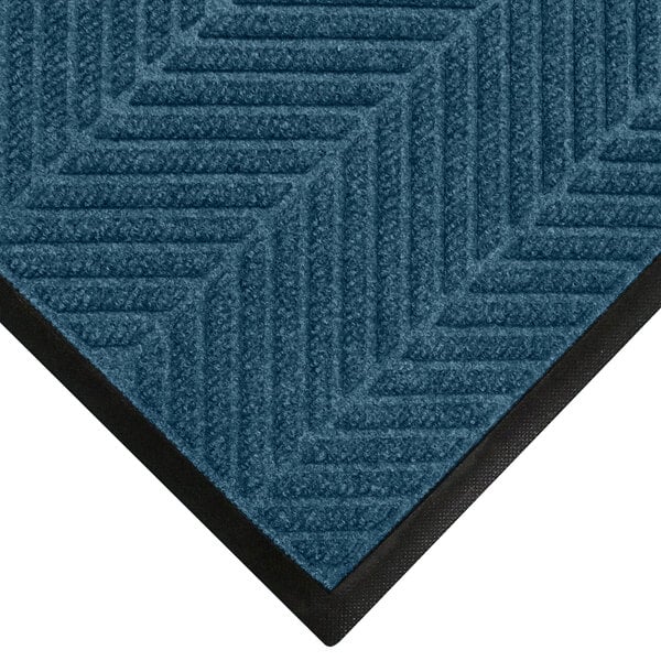 A WaterHog indigo mat with black border.