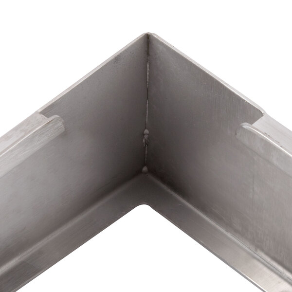 A close up of a stainless steel corner adapter plate.