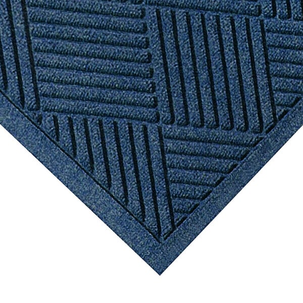 A close-up of a M+A Matting navy WaterHog mat with a square pattern.