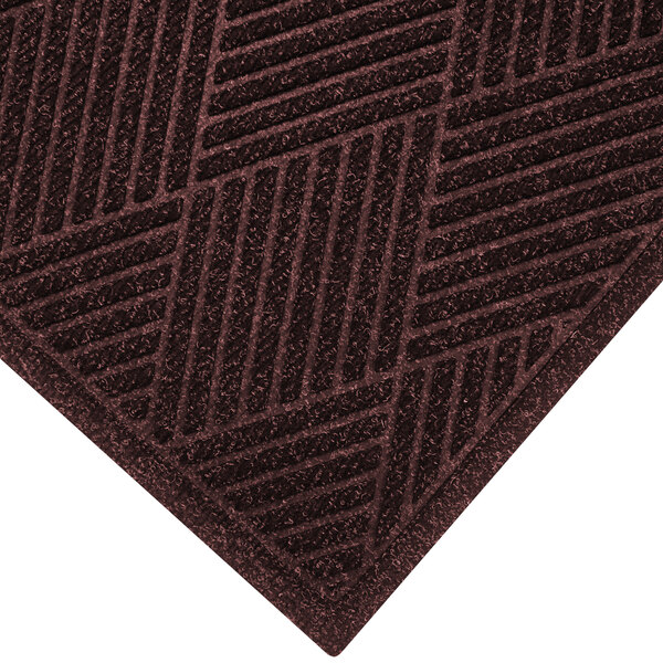 A maroon WaterHog entrance mat with a patterned border.