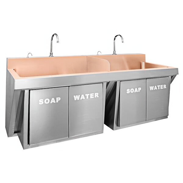 A white wall-hung Just Manufacturing copper scrub sink with two bowls, two faucets and soap valves.
