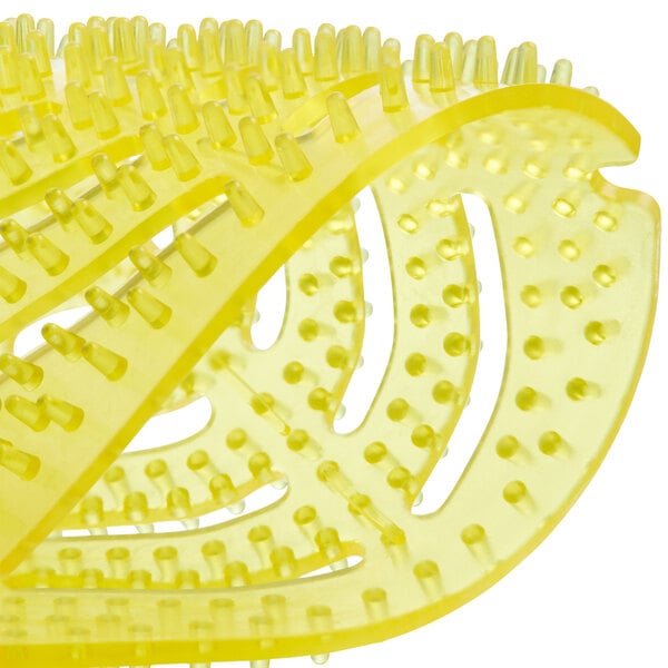 A close up of a yellow Lavex urinal screen.