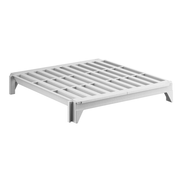 A white plastic Cambro Camshelving premium vented shelf with holes.