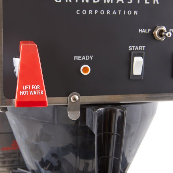 A Grindmaster commercial coffee brewer in a room.