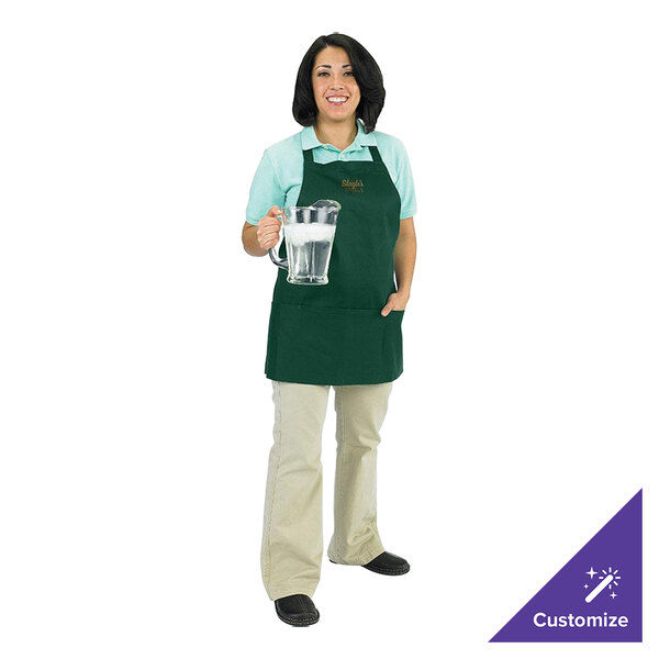 A woman wearing a Chef Revival hunter green apron holding a glass of water.