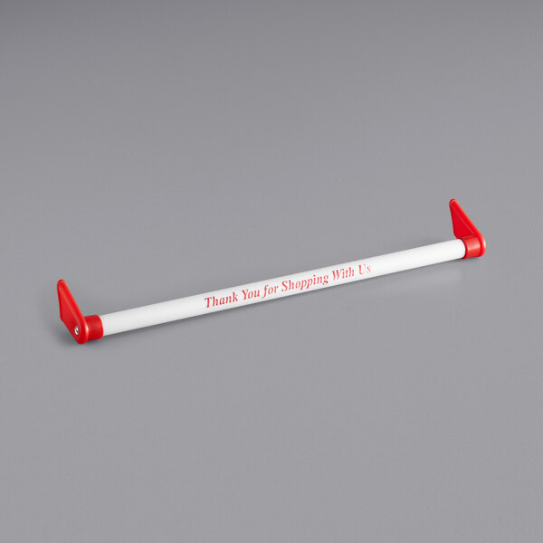 A white paper with red writing reading "Thank you for shopping" attached to a red and white Regency shopping cart handle.