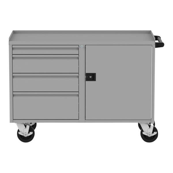 A grey metal Valley Craft workbench with drawers and a door.