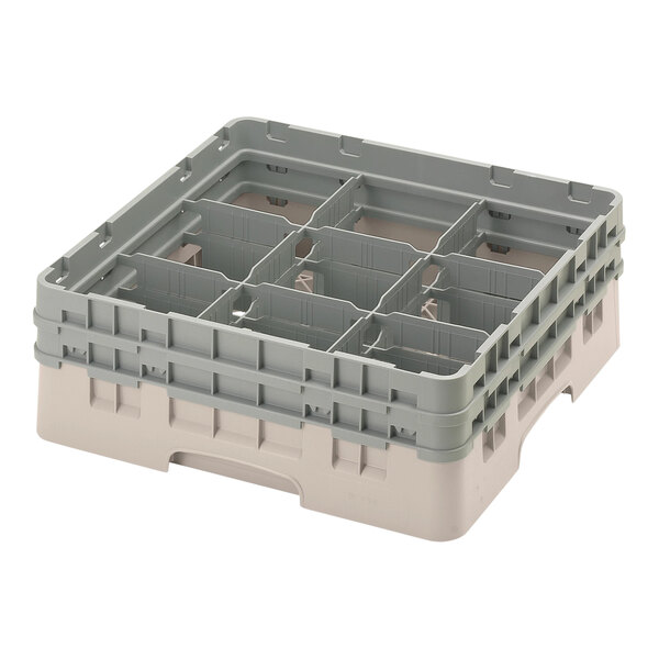 A beige plastic Cambro glass rack with 9 compartments and 2 extenders.