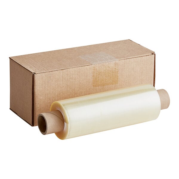 A roll of Western Plastics clear perforated plastic wrap next to a cardboard box.