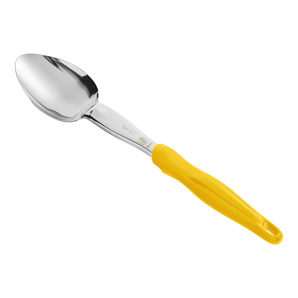 A Vollrath Jacob's Pride heavy-duty basting spoon with a yellow Ergo grip handle.