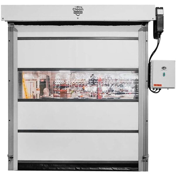 A white industrial vinyl door with a window and black control box.