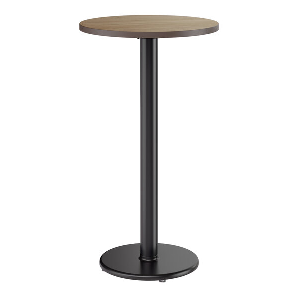 A round bar height table with a reversible birch or ash laminated top and a black cast iron base.