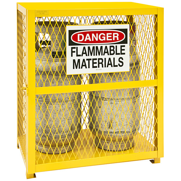 A yellow metal container with two cylinders inside.