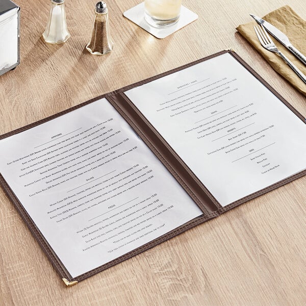 A brown Choice menu cover on a table with silverware and a glass.