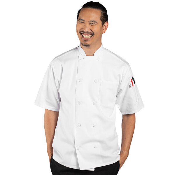 A man wearing a white Uncommon Chef Tingo short sleeve chef coat.