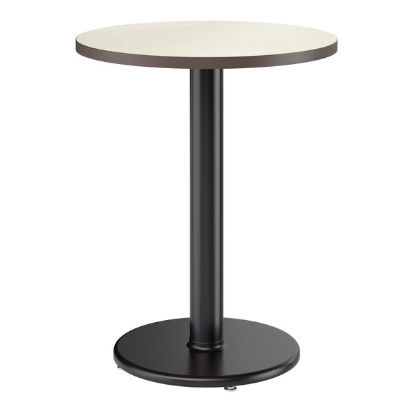 A round standard height table with a light-colored laminated top and a black cast iron base.