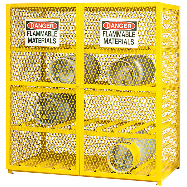 A yellow metal cabinet with several metal cylinders inside.