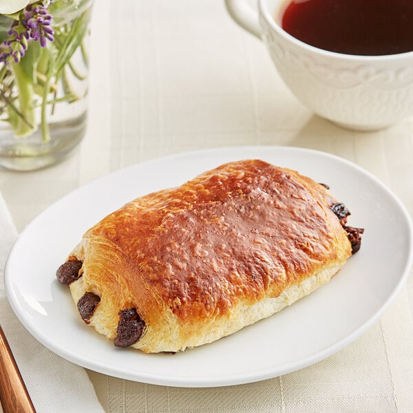 A Bridor Perfect Butter Chocolatine with chocolate and raisins on it.