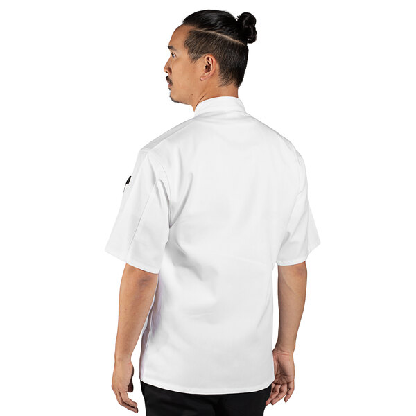 A man wearing a white Uncommon Chef short sleeve chef coat.