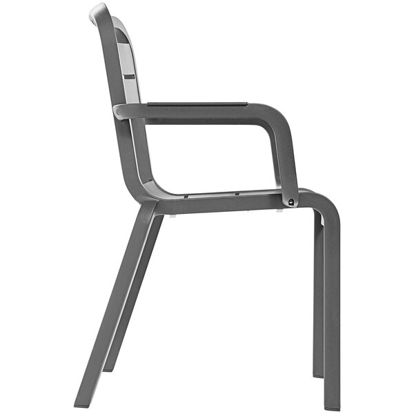 A gray Grosfillex outdoor armchair with armrests.