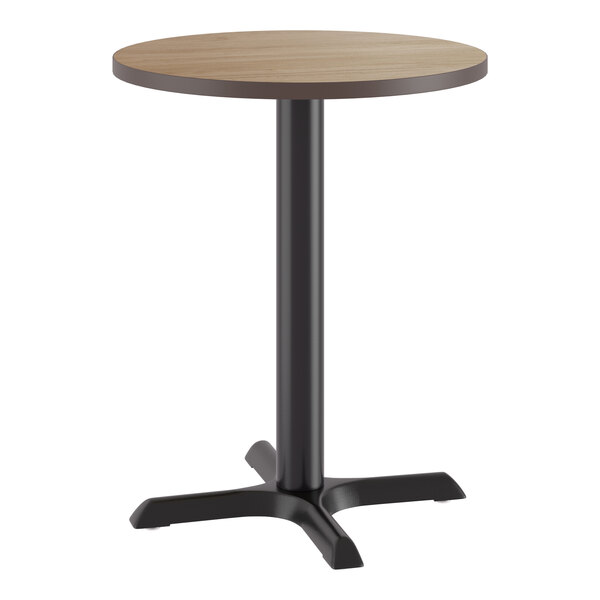 A round table with a birch or ash laminated top and a black cast iron base.