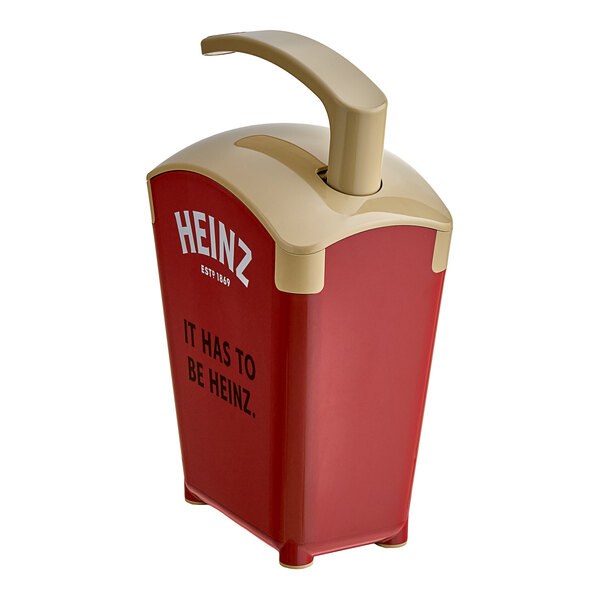 A tan and red plastic Heinz countertop pump dispenser with a lid and handle.