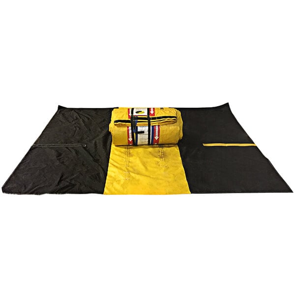 A rolled up yellow and black Quick Dam Water-Gate on a black surface.