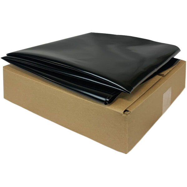 A brown box with a black plastic bag of Quick Dam polyurethane drain seals on top.